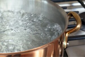 Pot of water boiling on a gas stovetop
