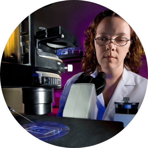 Julie in front of a dissecting microscope at work. Circa 2009.