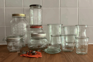 Various styles of canning jars commonly used in Germany, sitting on a wooden surface