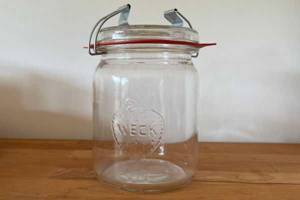 Vintage style Weck canning jar on a wooden surface