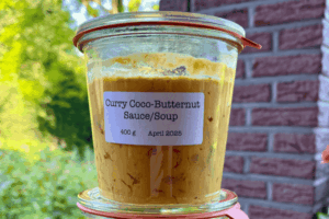 Weck jar containing bright yellow homemade Curry Coconut Butternut Soup