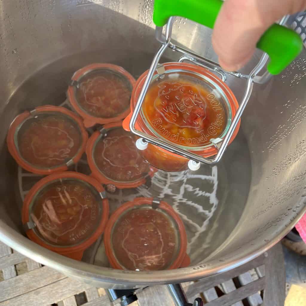 Canning-with-Weck-jars - 15 Using a jar lifter to remove jar of salsa from the water bath canner