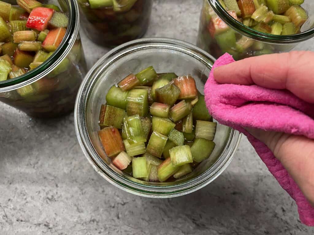 Canning-with-Weck-jars - 5 Wiping the jar rims before putting on the lids